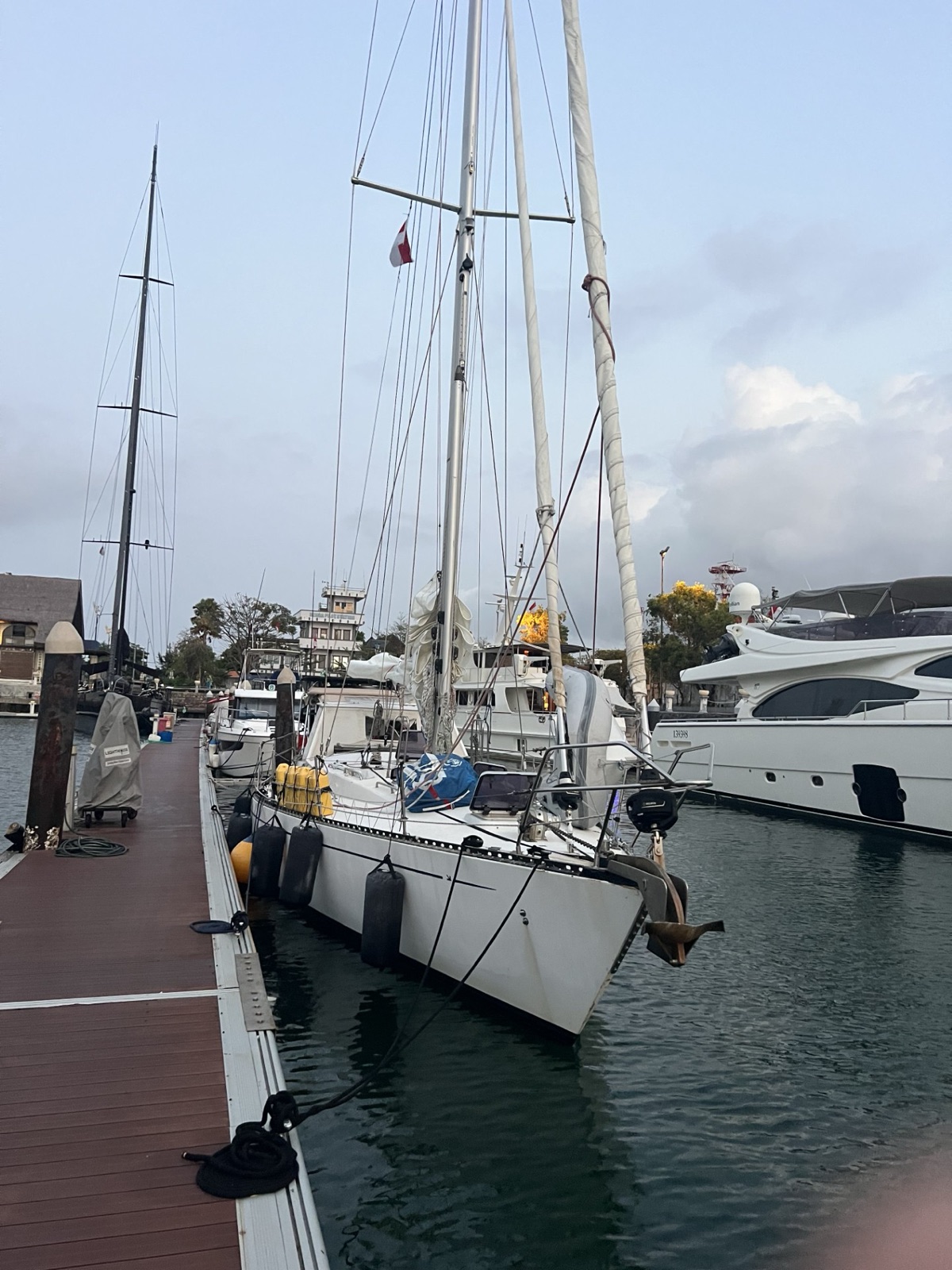 Quetzal at Benoa Harbour the evening before. Fenders out, jerry cans lashed forward, superyacht neighbors unimpressed.