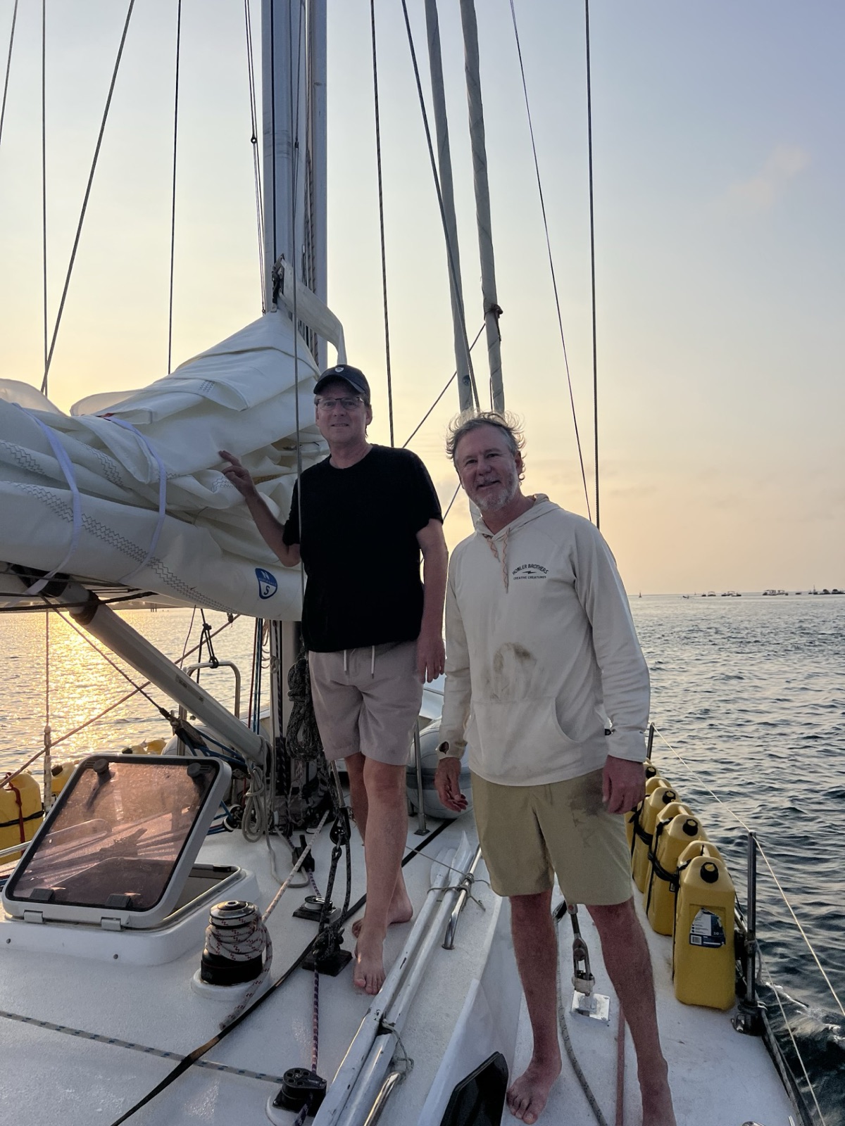 Peter and crewmate Greg on deck at the marina, morning of departure. Barefoot is the dress code for the next 3,429 miles.