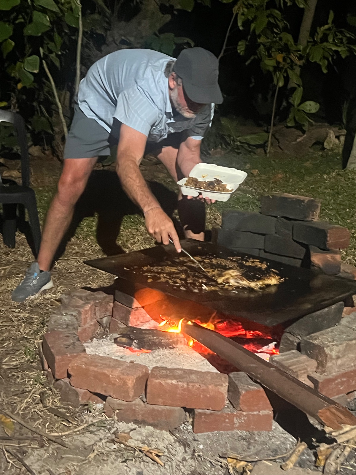 Greg is cooking here. The dark area in the background is the ocean. We are right on the beach. Earlier a local guy caught a bone fish in less than 5 minutes.